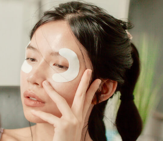 Woman applying eye mask