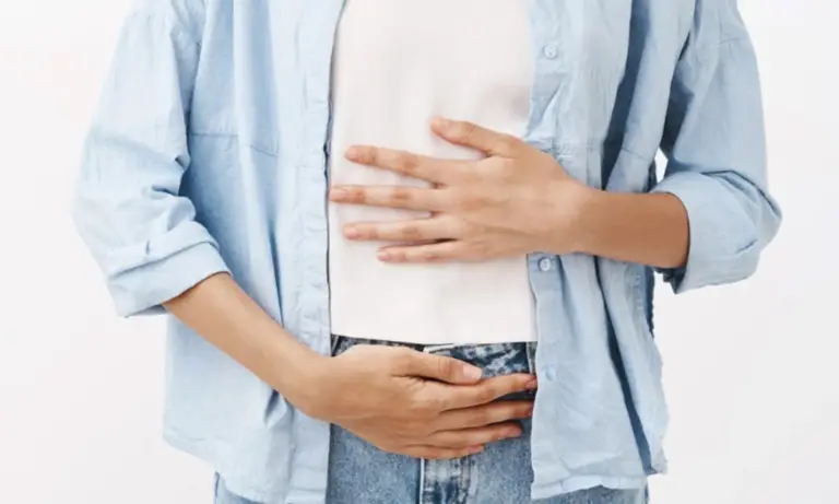 Woman holding her stomach in pain