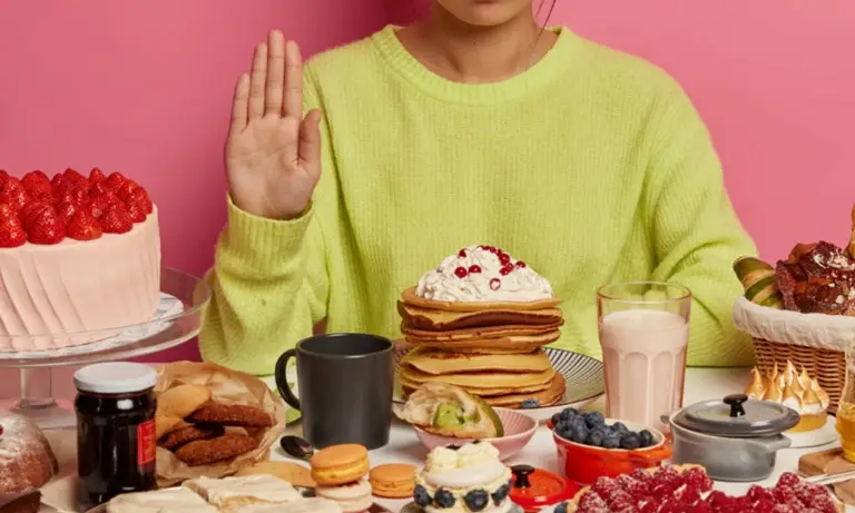 Woman sitting at a table with a lot of food