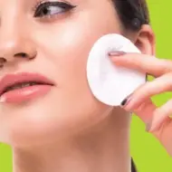 Photo of a woman with face cleaning pad