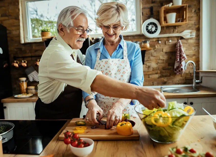 Happy mature couple cooking