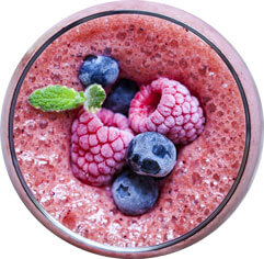glass of smoothie with red fruits
